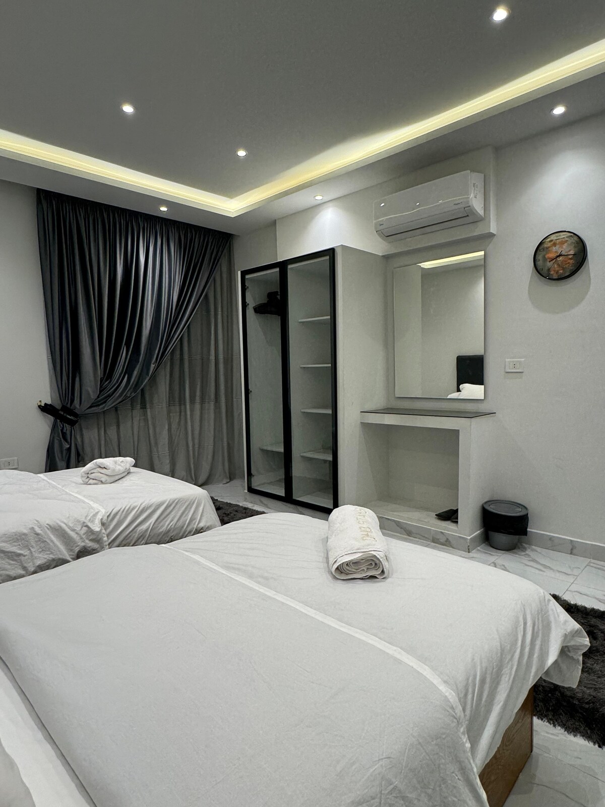 Twin bedroom — vanity under the A/C
